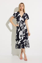 Load image into Gallery viewer, An elegant dress, our Melinda fit and flare dress is a flattering design in a brilliant midnight blue and vanilla color. Featuring a flattering cross-over front, elastic tie waist double frill hemline and frill cap sleeves this dress has elegant movement and is attractive on all figures.