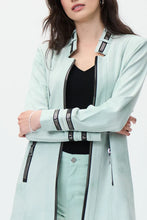 Load image into Gallery viewer, Simply stunning is this gorgeous mint faux suede jacket designed by Joseph Ribkoff. With its polished and classic design and amazing color, you will definitely get noticed when you style this jacket. Black faux zipper detailing along the neckline, sleeves and front creates an appealing contrast against the mint background. The longer length provides excellent coverage.