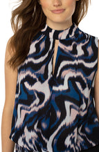 Load image into Gallery viewer, This beautiful floating ink printed top in nautical blue, black, white and soft pink is a fabulous statement piece featuring a mock neck slit and smocked waistband. With a great fit, providing all day comfort, our Mandi can be worn alone or under your favorite jacket or blazer. An outstanding outfit includes this top paired with your favorite white bottom. Color- Floating Ink; Blue, black, white and soft pink. Split front. Sleeveless. Banded elastic bottom. Blousy design. Not stretch fabrication.