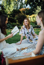 Load image into Gallery viewer, This gorgeous flowy fit dress will easily become your next favorite! A delightful mixture of colors including golden yellow, grays, greens, burgundy, pink and white come together to create a striking design. The flowy sleeves to the elbow and the tie at the waist create a romantic look that will make you feel pretty and classy at the same time.