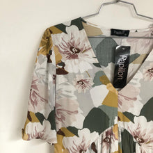 Load image into Gallery viewer, This gorgeous flowy fit dress will easily become your next favorite! A delightful mixture of colors including golden yellow, grays, greens, burgundy, pink and white come together to create a striking design. The flowy sleeves to the elbow and the tie at the waist create a romantic look that will make you feel pretty and classy at the same time.