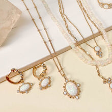 Load image into Gallery viewer, A gorgeous design on the New Lourdes Opal Necklace creates a lovely pendant that can be worn for all occasions. A gorgeous oval opal is surrounded by gold detailing and four cubic zirconia. The intricate chain has small gold beading. The beauty is in the details and our New Lourdes necklace is a beauty in its own right.