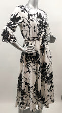 Load image into Gallery viewer, Every fabulous woman needs a black and white dress to showcase her beauty and our Vivien Black and White Floral Mid Length Dress by Papillon is the perfect dress to do just that. Whether you are going to a garden party, a wedding or a lovely dinner, this dress will make you feel like royalty. Colors- Black and White floral. Tie waist belt. Mid length.