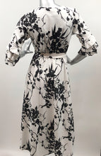 Load image into Gallery viewer, Every fabulous woman needs a black and white dress to showcase her beauty and our Vivien Black and White Floral Mid Length Dress by Papillon is the perfect dress to do just that. Whether you are going to a garden party, a wedding or a lovely dinner, this dress will make you feel like royalty. Colors- Black and White floral. Tie waist belt. Mid length.