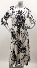 Load image into Gallery viewer, Every fabulous woman needs a black and white dress to showcase her beauty and our Vivien Black and White Floral Mid Length Dress by Papillon is the perfect dress to do just that. Whether you are going to a garden party, a wedding or a lovely dinner, this dress will make you feel like royalty. Colors- Black and White floral. Tie waist belt. Mid length.