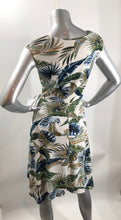 Load image into Gallery viewer, An absolutely gorgeous dress, our Winslow White Tropical dress drapes beautifully and is figure flattering. A white background comes alive with a tropical fern print and is enhanced with a gorgeous, attached tie that can be tied in the front or back. Worn to lunch or a night out. This gorgeous summer dress will make a fashion statement.