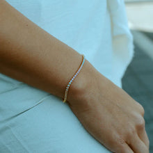 Load image into Gallery viewer, A beautiful tennis bracelet with perfect pops of pastel, the Gracie is a lovely piece that can be layered or worn alone. Our Gracie bracelet will easily become your new favorite for the Spring/Summer. Add our Gracie Pastel Tennis necklace for extra sparkle! Colors- Clear, pink, blue, yellow and gold. Length -6.5" with a 1.5" extender. Cubic zirconia. 14k gold plating over brass.