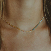 Load image into Gallery viewer, A beautiful tennis necklace with perfect pops of pastel, the Gracie is a lovely piece that can be layered or worn alone. Our Gracie necklace will easily become your new favorite for the Spring/Summer. Add our Gracie Pastel Tennis bracelet for extra sparkle! Colors- Clear, pink, blue, yellow and gold. Length -6.5" with a 1.5" extender. Cubic zirconia. 14k gold plating over brass.