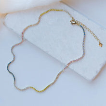 Load image into Gallery viewer, A beautiful tennis necklace with perfect pops of pastel, the Gracie is a lovely piece that can be layered or worn alone. Our Gracie necklace will easily become your new favorite for the Spring/Summer. Add our Gracie Pastel Tennis bracelet for extra sparkle! Colors- Clear, pink, blue, yellow and gold. Length -6.5" with a 1.5" extender. Cubic zirconia. 14k gold plating over brass.