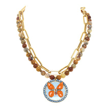 Load image into Gallery viewer, Add greater interest to your everyday outfits with this beautiful butterfly pendant necklace by TOVA. A bright orange hand painted butterfly pops on top of a light blue background surrounded by light blue crystals. This stunning pendant hangs from a duel multi bead and gold link chain.