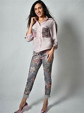 Load image into Gallery viewer, A little edge, a little sass and a lot of class is our Bella Pink Sparkle Blouse by Frank Lyman. The uniqueness is in the details and this gorgeous blouse has many. The left pocket is covered in sparkling pink beading with the words, Eternal, Love, Sweet, Toujours, Passion, Amore, Live, Laughter and more. The printed words and hearts dance on and around the pocket. The right pocket sparkles in pink beading and has a bar of clear and black crystals in a checkered pattern.