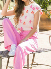 Load image into Gallery viewer, Pretty in pink describes how you'll feel when you put on this lovely short sleeve top. A beautiful true pink base has pops of bright orange and fuchsia flower motifs. The sleeves, neckline and bottom include a contrast ribbed trim in white creating even more interest. A perfect top to pair with shorts or jeans or wear under a jean jacket, you cannot go wrong with this adorable top.