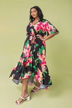 Load image into Gallery viewer, The Ellie Woven Maxi Dress is so stunning with a black background and a floral print that just pops! This gorgeous style features a surplice neckline and is a true wrap design with a ruffled hemline. A dress for those perfect moments in your life.