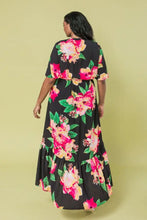Load image into Gallery viewer, The Ellie Woven Maxi Dress is so stunning with a black background and a floral print that just pops! This gorgeous style features a surplice neckline and is a true wrap design with a ruffled hemline. A dress for those perfect moments in your life.