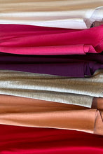 Load image into Gallery viewer, A closet isn't complete without a basic tee! The Lisa white tee is an ideal piece to have on hand when you need a top to place under a jacket, blazer or cardigan. It is also perfect just to wear on its own and with the detailing of side slits, V-neck design and round hem, this tee has an upscale look.