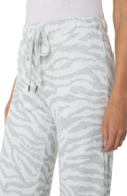 Load image into Gallery viewer, Sometimes, what you desire is just a casual and comfortable but fashionable outfit. Our Windam pull on pant in zebra print meets all those needs and more! With its soft fabrication, pull on ease, elastic waistband and drawstring closure, you can quickly get ready to face your day and run your errands.