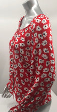 Load image into Gallery viewer, Small white flowers with black centers just pop on this gorgeous true red long sleeve top. The feminine touches create a romantic top with a scoop neckline and a row of button closures, as well as ruffled cuffs. A lightweight material, this will keep you cool in the warmer days and warm when there is a slight chill. This is the choice of top to pair with crisp white bottoms and effortlessly goes well with jeans.
