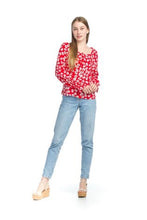 Load image into Gallery viewer, Small white flowers with black centers just pop on this gorgeous true red long sleeve top. The feminine touches create a romantic top with a scoop neckline and a row of button closures, as well as ruffled cuffs. A lightweight material, this will keep you cool in the warmer days and warm when there is a slight chill. This is the choice of top to pair with crisp white bottoms and effortlessly goes well with jeans.