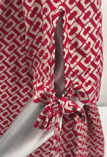 Load image into Gallery viewer, Our Rylee Raspberry Tie Sleeve Top is so versatile. With a raspberry and tan color geometric pattern, you create so many different looks with this lovely top. Pair with tan, white or black bottoms to create a dressier look or wear with jeans for a more casual look.
