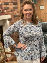 Load image into Gallery viewer, A gorgeous Mandala textured print comes alive on this fabulous bell sleeve top. A beautiful white print pops on a navy sheer fabric, making this a very versatile top. Perfect paired with white bottoms or jeans and easily goes from day wear to an evening out. Colors- White and Navy. Mandala textured print. Bell Sleeve. Slight Hi-lo design. Slightly longer in the back.