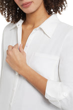 Load image into Gallery viewer, There's nothing better than a flowy tunic top to elevate any outfit! This flowy white button up shirt has all the classic details we love including a hidden button placket, roll-up tab cuffs, a chest patch pocket and curved shirttail hem on a high lo look. Proudly wear on its own or put under a sweater vest, which is this season's hottest look!