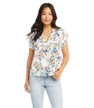 Load image into Gallery viewer, The feminine romantic style of this top is enhanced by pintuck pleating at the shoulders, ruffled neckline details, and small-scale florals. Wear it with your favorite jean and stylish sandal for an on-trend look. Colors- Primarily white with vibrant blue, green, yellow and pink flower print.