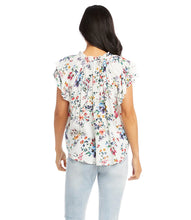 Load image into Gallery viewer, The feminine romantic style of this top is enhanced by pintuck pleating at the shoulders, ruffled neckline details, and small-scale florals. Wear it with your favorite jean and stylish sandal for an on-trend look. Colors- Primarily white with vibrant blue, green, yellow and pink flower print.
