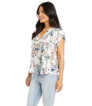 Load image into Gallery viewer, The feminine romantic style of this top is enhanced by pintuck pleating at the shoulders, ruffled neckline details, and small-scale florals. Wear it with your favorite jean and stylish sandal for an on-trend look. Colors- Primarily white with vibrant blue, green, yellow and pink flower print.