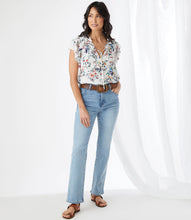 Load image into Gallery viewer, The feminine romantic style of this top is enhanced by pintuck pleating at the shoulders, ruffled neckline details, and small-scale florals. Wear it with your favorite jean and stylish sandal for an on-trend look. Colors- Primarily white with vibrant blue, green, yellow and pink flower print.