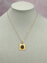 Load image into Gallery viewer, If you want a stylish piece of jewelry that is as unique as you are, our Skyla necklace fits that category. This dainty iridescent vintage CC button sits beautifully on a square gold pendant setting and hangs from a shiny gold necklace. The iridescent colors in the button flash with every move and catches the eye. 