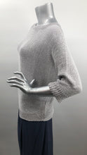 Load image into Gallery viewer, A perfect sweater for all year round, as it is not too heavy and not too light, this knit sweater is fashionable and functional. The silver-gray color is so on trend and literally goes with so many different bottoms. As this 3/4 sleeve sweater is not a tight knit, it is slightly see-through. Wear over a bralette, tank or nude bra if preferred.