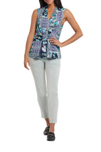 Load image into Gallery viewer, We love this easy sleeveless blouse in the softest printed woven fabric. Gorgeous blues, yellow, green and white colors come together to create an eye appealing medley of color while a front tie defines the waist. Dress this top up for work or wear casually while running errands, this stunning flowy top is a must have in your wardrobe. Color- Lagoon; white, blues, green, yellow. Pop-over V-neck. Flowy fit. Faux front tie.