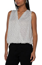 Load image into Gallery viewer, This classic dot printed top features a draped front for the most flattering fit. The V-neck design elevates the look of this lovely sleeveless top. A perfect top to match with so many different bottoms from jeans to dress pants. Create the perfect outfit when paired with our Black Sena Boyfriend Blazer with Princess Seams by Liverpool LA and our Black Kelsey Knit Trouser by Liverpool LA.