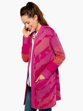 Load image into Gallery viewer, The Sun Chaser Cardigan sweater features an artistic, one-of-a-kind jacquard knit with colors that are joyful, bright and expressive. This cozy cardigan is designed with a soft, midweight yarn which has an easy, relaxed fit. Color- Multi pink. Cardigan sweater with open front. Jacquard knit with original artwork. Midweight. Relaxed fit. Shawl collar.