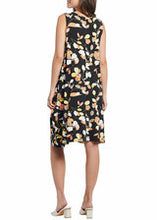 Load image into Gallery viewer, A gorgeous dress with utmost comfort during those hot, humid days is a must have in your summer wardrobe. A flattering fit for all figures, the Ellie dress tapers down from a small gathering at the end of the V-neck and gracefully flares from there. The most darling leaf pattern in colors of papaya, black and cream and adorn this gorgeous sleeveless dress.