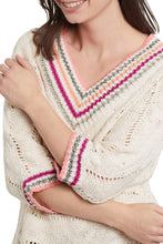 Load image into Gallery viewer, A lightweight layering piece is a wardrobe essential! With its classic v-neck, a bold color pattern trims the collar and cuffs while the cotton slub knit and 3/4 length drop shoulder sleeves offer all the relaxed vibes we all love. Color- Natural with fuchsia, olive green, orange and coral trim. Pop-over V-neck. Relaxed fit. 3/4 dolman sleeves. Contrast collar and cuff trim. Cotton slub knit.