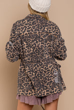 Load image into Gallery viewer, If you are looking for something new with a vintage vibe, our Virginia jacket is the perfect transitional jacket for you. Designed with a relaxed fit, the Virginia jacket has a hidden placket and zipper closure on center front and a great leopard print. Comes with a four-pouch pocket on front with an adjustable strap on the waistband and finished with distressed detail throughout the garment for vintage look. Color-Light brown base with black leopard print. Relaxed fit; no stretch.