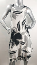 Load image into Gallery viewer, A classic dress, this black, white and gray biased cut dress will easily become your next favorite. A lovely abstract floral pattern adorns this two-tier hem dress and with the sleeveless design, you can easily style with a cardigan or jacket. Fully lined.