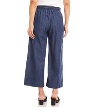 Load image into Gallery viewer, What is better than a pair of breezy, comfortable wide leg pant to keep you cool and comfortable during those warm, sunny days? Our Whitney Wide Leg Pant is just that, a breezy, roomy, Tencel cotton pant that features an elasticized waistband, functional front pockets and a front tie detail. A versatile bottom to wear casually or dressed up. Color- Denim blue. Elasticized waistband. Ankle length.