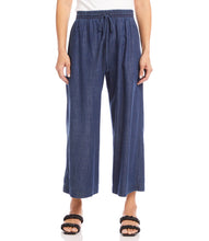 Load image into Gallery viewer, What is better than a pair of breezy, comfortable wide leg pant to keep you cool and comfortable during those warm, sunny days? Our Whitney Wide Leg Pant is just that, a breezy, roomy, Tencel cotton pant that features an elasticized waistband, functional front pockets and a front tie detail. A versatile bottom to wear casually or dressed up. Color- Denim blue. Elasticized waistband. Ankle length.