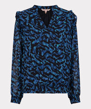 Load image into Gallery viewer, A gorgeous pop of all over blue in an animal print is striking on the Wilda Wild Celebration Blouse. The Wilda has a round neckline, decorative ruffles on the shoulders and smocked cuffs. Pair with a pair of faux leather or black pants or your favorite denim and boots and you'll be a fashionista!