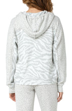 Load image into Gallery viewer, A soft and comfortable fabric, along with a stylish pattern, makes our Zora jacket a must have for the cooler months. Layer over a white or gray top and pair with your favorite jean or if you are looking for a complete fashionable set, pair with our WINDAM PULL ON WIDE LEG PANT WITH DRAWSTRING IN ZEBRA JACQUARD. Color- White and gray. Jacquard fabrication. Set in hooded neckline with drawstring. Long drop shoulder sleeves.