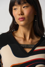 Load image into Gallery viewer, The Ronan Rhinestone V-Neck Top by Joseph Ribkoff is the perfect combination of elegance and contemporary style. This boxy top features a black silky knit and abstract patterned fabric in a unique mélange for a one-of-a-kind look. Finishing touches include a V-neckline with rhinestone trim and long straight sleeves with side slits. Create a unique style for any occasion.  Color- Black, white, red, brown, blue, orange. Silky knit fabric. V-neckline. Long straight sleeves.
