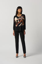 Load image into Gallery viewer, The Ronan Rhinestone V-Neck Top by Joseph Ribkoff is the perfect combination of elegance and contemporary style. This boxy top features a black silky knit and abstract patterned fabric in a unique mélange for a one-of-a-kind look. Finishing touches include a V-neckline with rhinestone trim and long straight sleeves with side slits. Create a unique style for any occasion.  Color- Black, white, red, brown, blue, orange. Silky knit fabric. V-neckline. Long straight sleeves.
