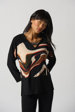 The Ronan Rhinestone V-Neck Top by Joseph Ribkoff is the perfect combination of elegance and contemporary style. This boxy top features a black silky knit and abstract patterned fabric in a unique mélange for a one-of-a-kind look. Finishing touches include a V-neckline with rhinestone trim and long straight sleeves with side slits. Create a unique style for any occasion.  Color- Black, white, red, brown, blue, orange. Silky knit fabric. V-neckline. Long straight sleeves.
