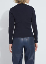 Load image into Gallery viewer, Model wearing a dark blue ribbed top and blue faux leather pants against a white background.
