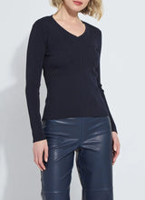 Load image into Gallery viewer, Model wearing a dark blue ribbed top and blue faux leather pants against a white background.
