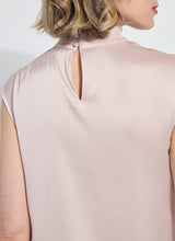 Load image into Gallery viewer, Close-up of the back of the light pink sleeveless blouse worn by a model.
