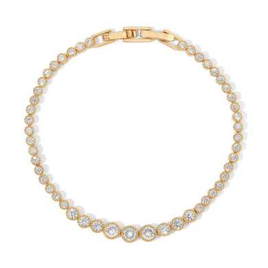 A graduated silhouette modernizes a classic tennis bracelet. Plated in 14-karat gold and lined with cubic zirconia, this sparkling piece of jewelry is an eye catcher and compliment maker.  Our Alexandria Graduated Bracelet matches perfectly with our Alexandria Graduated Tennis Necklace.  Color- Gold and Clear. 7 inch. 14 kt gold over brass.