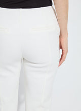 Load image into Gallery viewer, White pants worn by a model against a white background.

